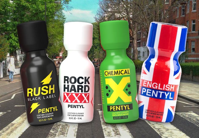 Four bottles of The Fab Four labeled "rush black label pentyl," "rock hard xxx pentyl," "chemical x pentyl," and "english pentyl," displayed in front of a British street.