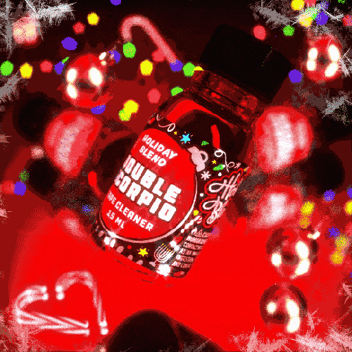 A festive-themed product called "Double Scorpio Holiday Blend - 10ml," floating amidst a sparkling and colorful holiday lights backdrop, creating a lively and seasonal atmosphere.